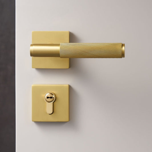 moderne cilindrische deurkruk op vierkant rozet uitgevoerd in mat messing met knurled motief