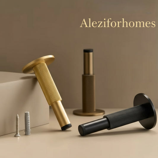 drie stuks deurstop brons, mat messing en zwart met knurled motief liggend op een beige ondergrond