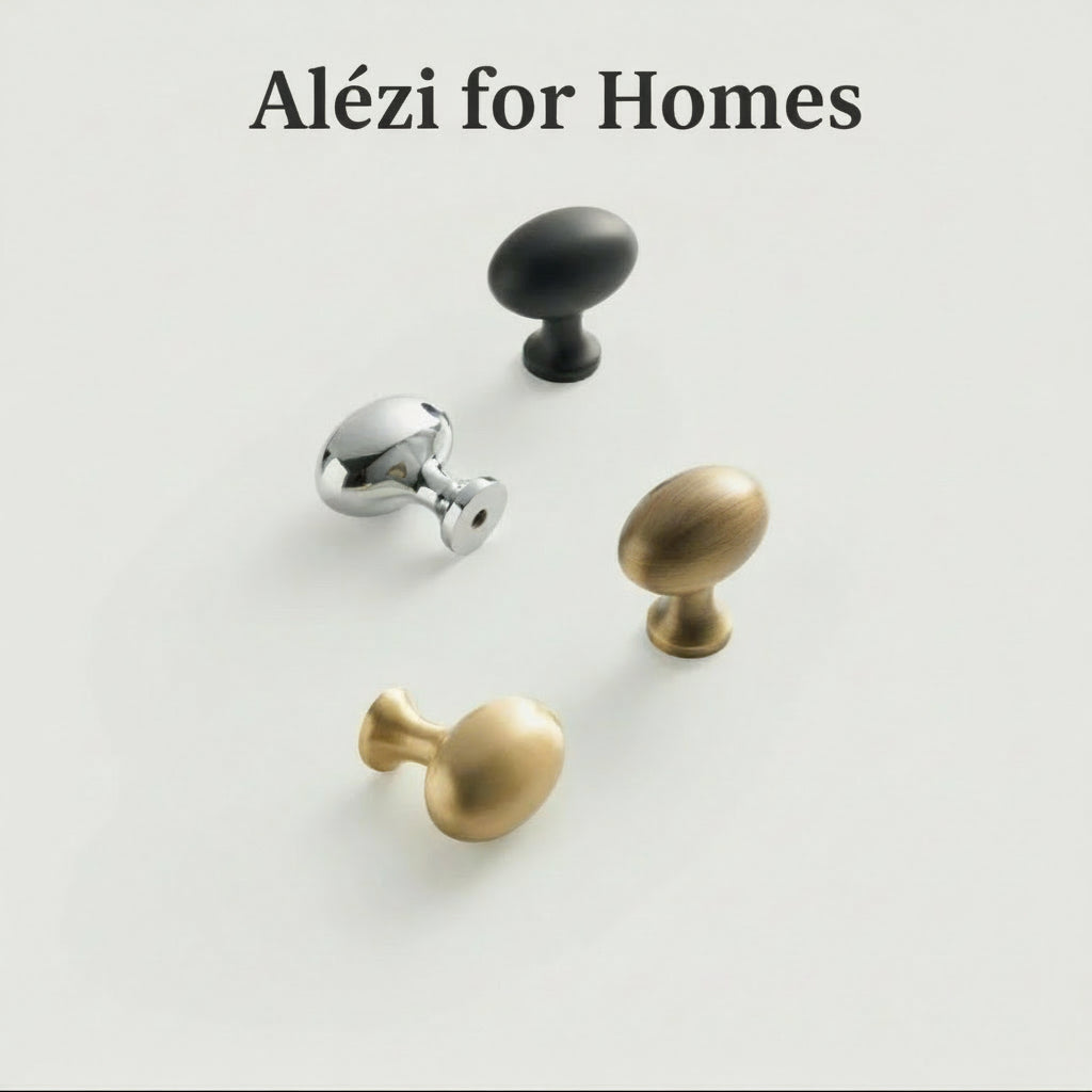 Vier eivormige meubelknopjes op een witte ondergrond in messing, brons en zwart